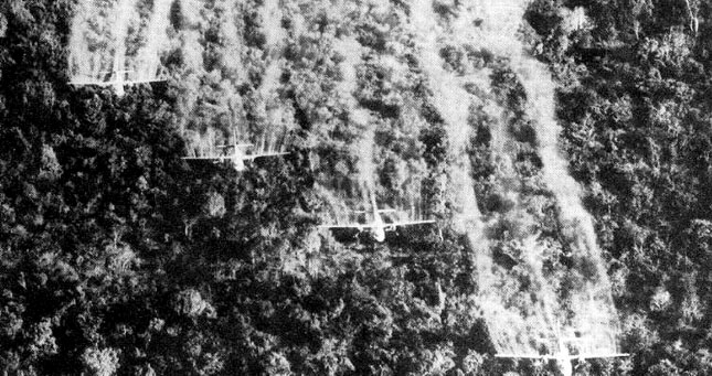 Black and white image of planes dropping agent orange