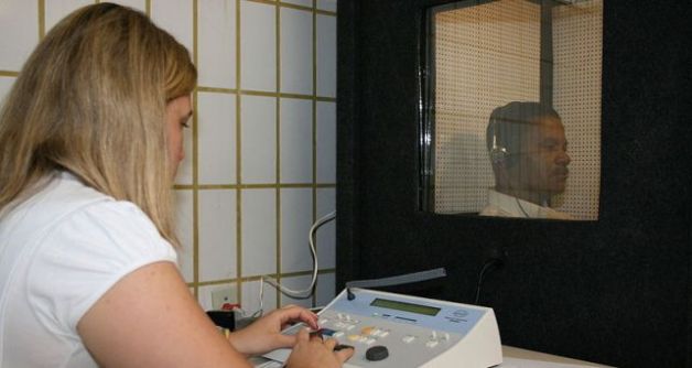 Technician administering hearing test