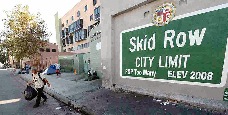 Sign on a wall in LA that reads Skid Row