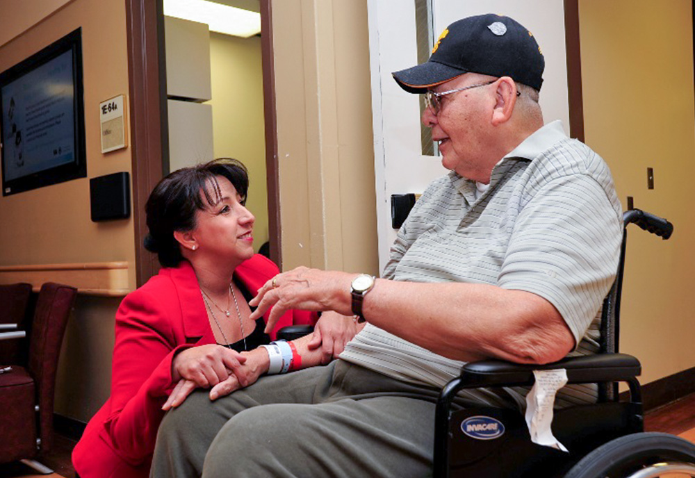 Nurse talking with patient in a wheelchair