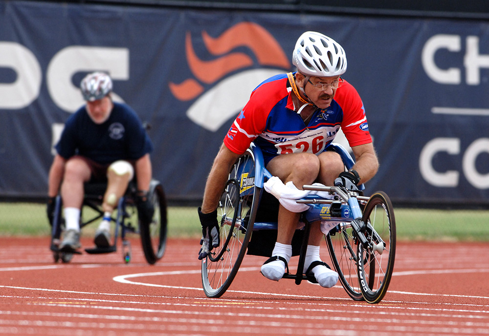 men racing in wheelchairs around a track