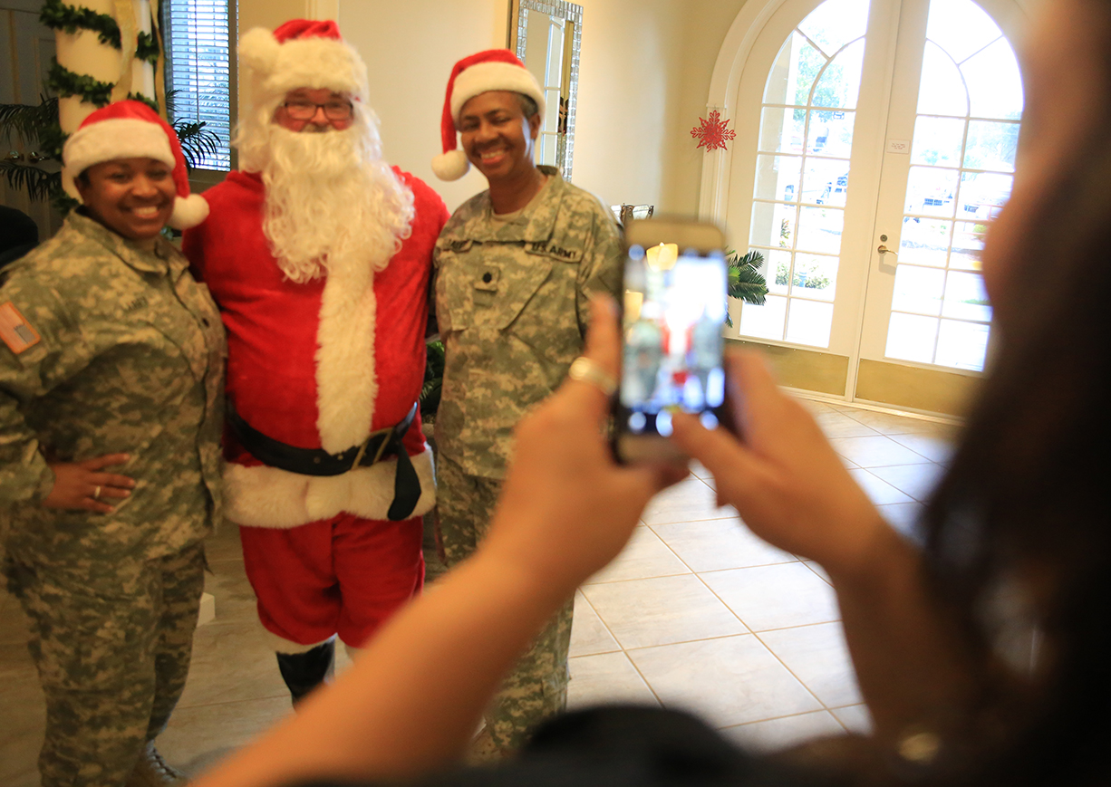 Servicemembers pose with Santa at the Tampa VA Fisher House