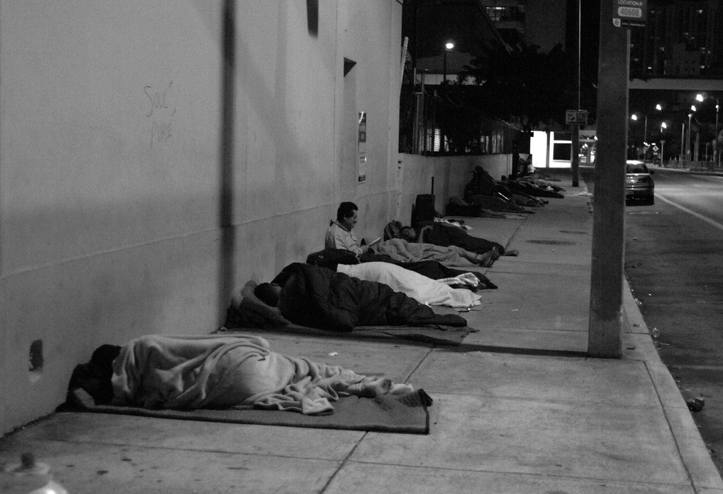 Homelss people sleep in the street.