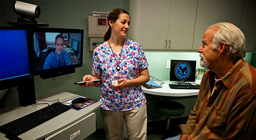Image of a patient and nurse using video camera