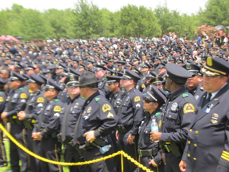 A sea of police offices attend the funeral of slain police officer killed in Dallas attacks.