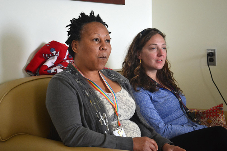 image of Ingra Anderson (left) and Rachelle Susko listen while other women express their thoughts during a group therapy session.