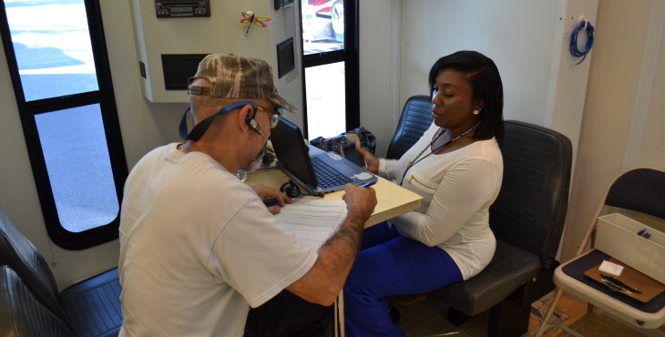 Advanced Medical Support Assistant and Army Veteran Sherry Montgomery talks to a Veteran while he checks in for an appointment about his health care. He stopped by the VA/MMU in Tarboro, N.C. for treatment when the unit was set up there to offer area Veterans health care in the aftermath of hurricane Matthew.