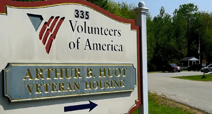 image of a Volunteers of America sign pointing to tranisitonal housing