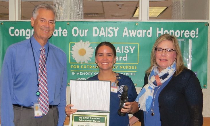 Martha Peak-Sweet, RN, is presented with her DAISY Award by Pam Crowell, Associate Director, and John Goldizen, Associate Deputy of Nursing and Patient Care Services.