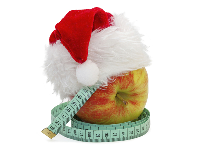 image of an Apple with a measuring meter, in a cap Santa Claus