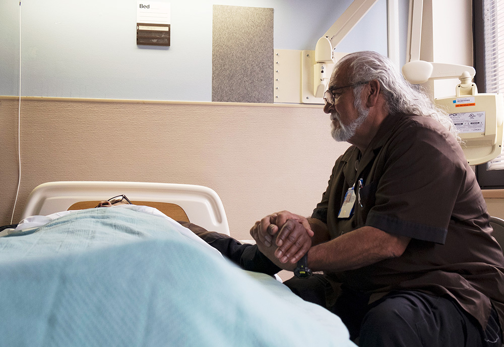 Images of Julian Scadden at the bedside of a dying Veteran