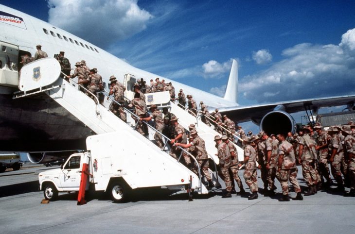 Marines boarding a commercial aircraft to support coalition forces for Operation Desert Shield.