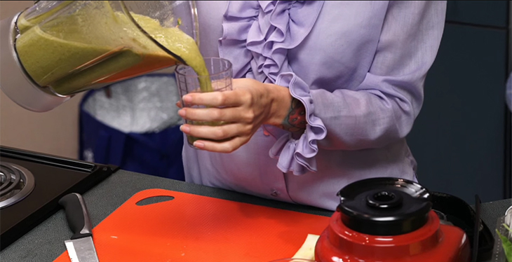close up image of a person pouring a smoothie.