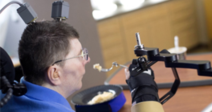Image: Bill Kochevar, a Navy Veteran and spinal cord injury patient, participates in BrainGate2 research, using the implanted technology to move his arm.
