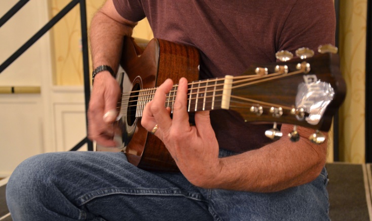 image of a man playing a guitar