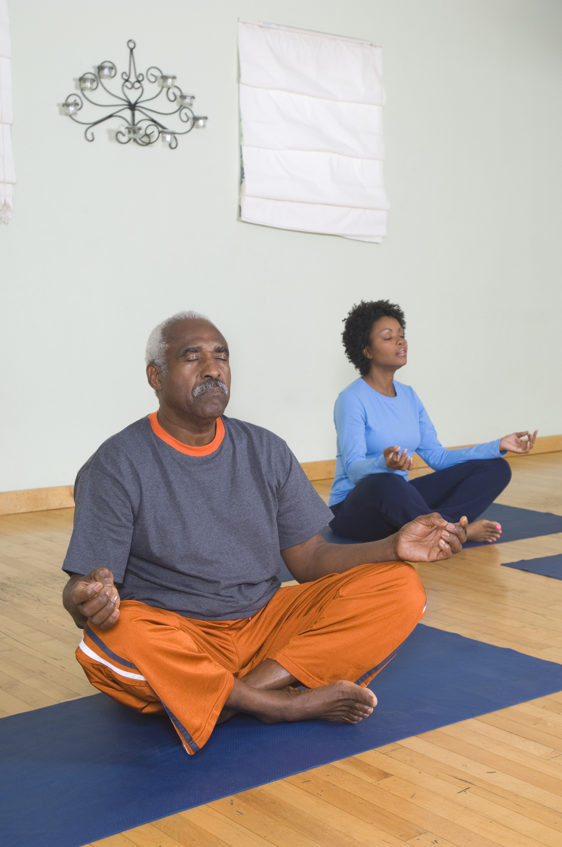 IMAGE: Senior Man Meditating in Yoga Class