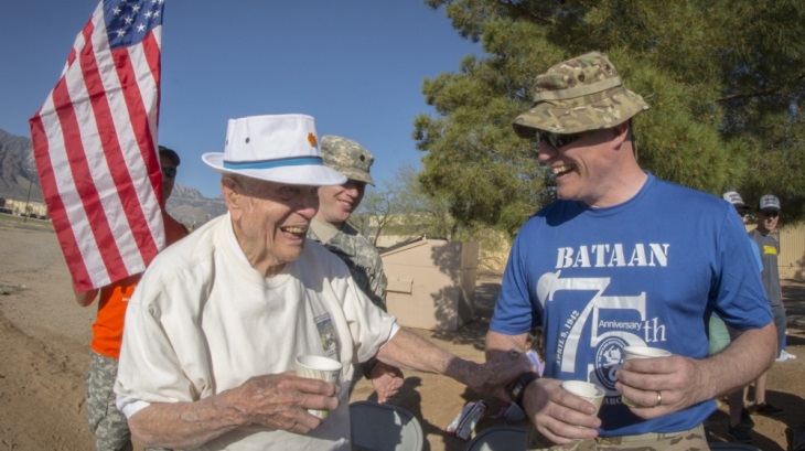 Image: Retired U.S. Army Col. Ben Skardon, 99, a survivor of the Bataan Death March, shares a laugh with Master Sgt. Mike Lavigne, a volunteer at water station one of the Bataan Memorial Death March, at White Sands Missile Range, N.M., March 18, 2017. Skardon is the only Bataan survivor who walks in the memorial march. He walks eight and a half miles and this was the tenth time he did it. (U.S. Army Reserve photo by Staff Sgt. Ken Scar)