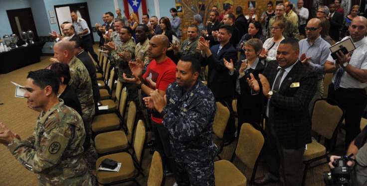 Audience members applaud during a Warrior Training Advancement Course graduation ceremony Mar. 30. The department of Veterans Affairs and Defense Department partnership training course prepares transitioning service members to join VA as Veteran service representatives. (U.S. Army photo by Spec. Anthony Martinez)