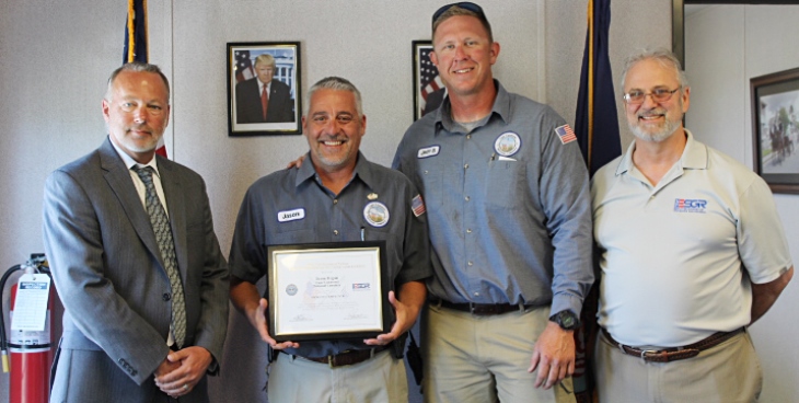 IMAGE: Jason Hogan, Cape Canaveral National Cemetery foreman, center-left, received a Patriot Award in recognition for his outstanding support of the military during a ceremony April 19, 2017. Pictured, from the left are Don Murphy, Cape Canaveral National Cemetery Director; Jeffrey Brawner, cemetery caretaker and Jack Giralco, Employer Support of the Guard and Reserve representative, April 19, 2017.