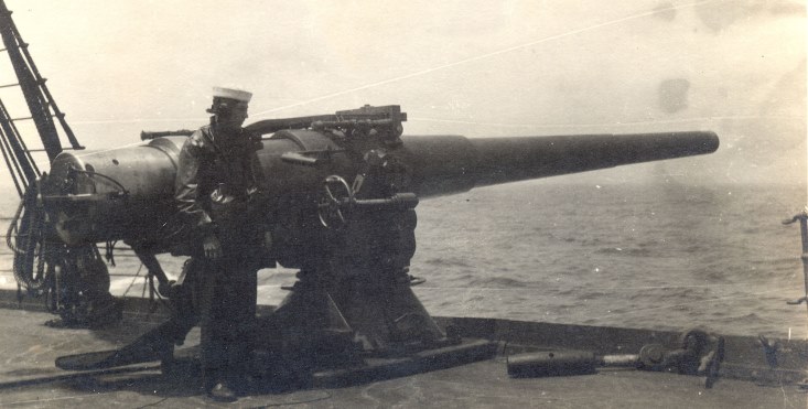 IMage of a sailor and a large gun on the USS Mongolia