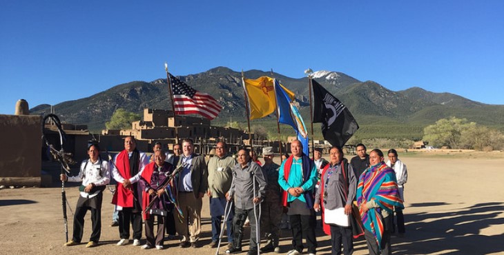 Image: VA officials with tribals members with the mountains in the background.