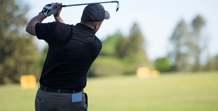 Image of a progolfer following through on a drive.
