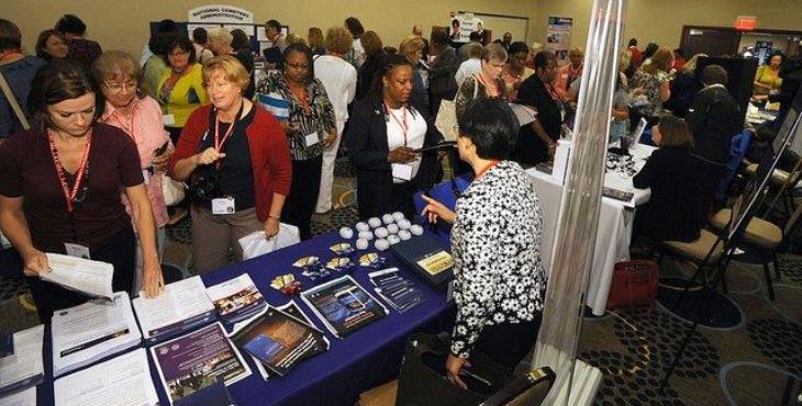 Images of women viewing static displays at a conference