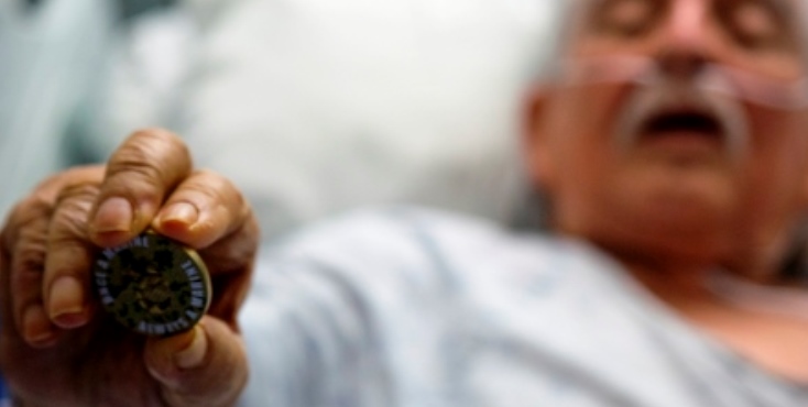 IMAGE Fidel Gomez holding a coin