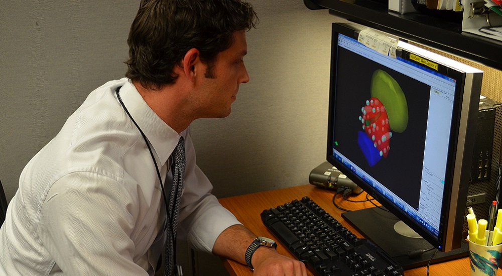 Dr. Matthew Schutzer examines a 3-dimensional diagram in preparation for the placement of radiated seeds which are placed into a patient’s prostate to fight cancer cells.