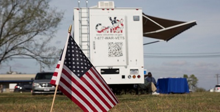 Image: A small U.S. flag planted near a mobile Vet Center that deployed to assist shooting victims and family members.