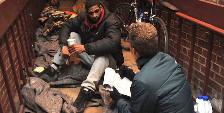 IMAGE: A homeless Veteran talks with volunteer during the annual PIT count.