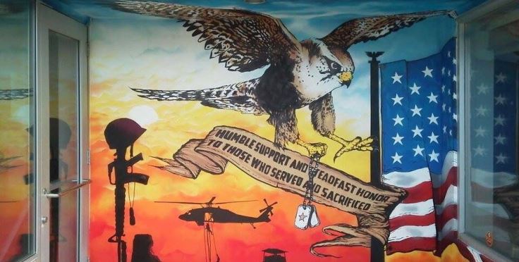 IMAGE: A paining on the Newby-ginnings building featuring an owl carrying dog tags