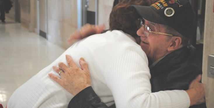 IMAGE: A VA Volunteer shares a hug with a Veteran