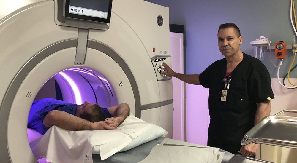 U.S. Army Veteran Jim Altman receives lung cancer screening facilitated by CT Technologist, Miguel Santiago at the C.W. Bill Young VA Medical Center.
