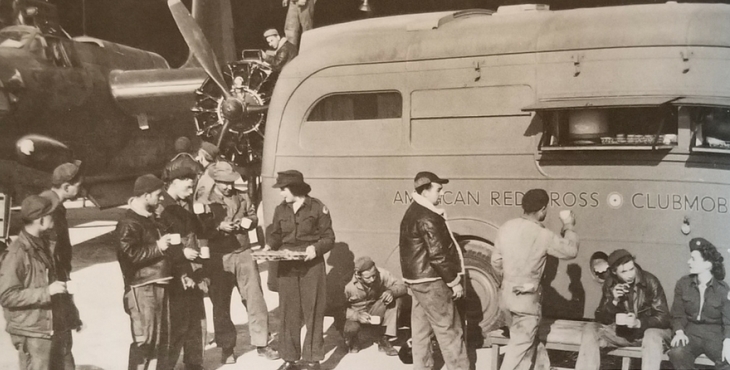 IMAGE: Troops gather around a Red Cross mobile in Europe during WW II.