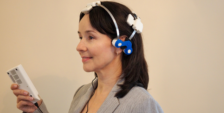 Dr. Yelena Bogdanova, Clinical Psychologist at VA Boston Healthcare System, demonstrates the LED therapy headset.