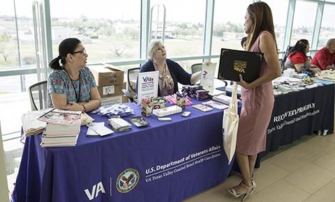 (At right) Army Veteran Ms. Laura B. Vela, stops by the information booth manned by Ms. Kathleen Libke (Women Veteran Program manager) and Aleli Duque (Women Health Care coordinator), who provided information and educational material regarding Women Veteran health matters to guests at the photo exhibit, which opened to the public after VA Texas Valley Coastal Bend Health Care System's ceremony held in observance of this year’s Women History Month, which took place March 2, 2018, at the VA Health Care Center at Harlingen, Texas. The Women Veterans Health information booth was one of several VA and community organizations participating in the series of events and activities held in observance of national Women's History Month. (U.S. Department of Veterans Affairs photo/Luis H. Loza Gutierrez)