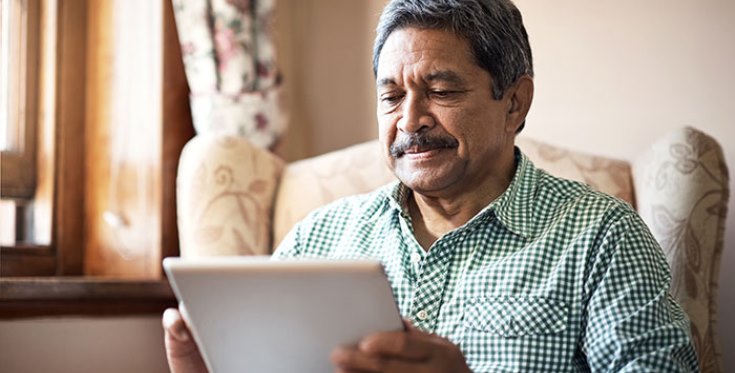 IMAGE: An older Veteran using a tablet