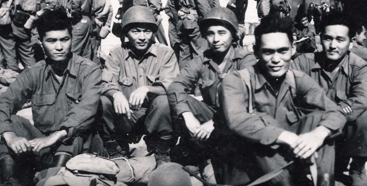 black and white photograph that shows a group of nisei soldiers relaxing