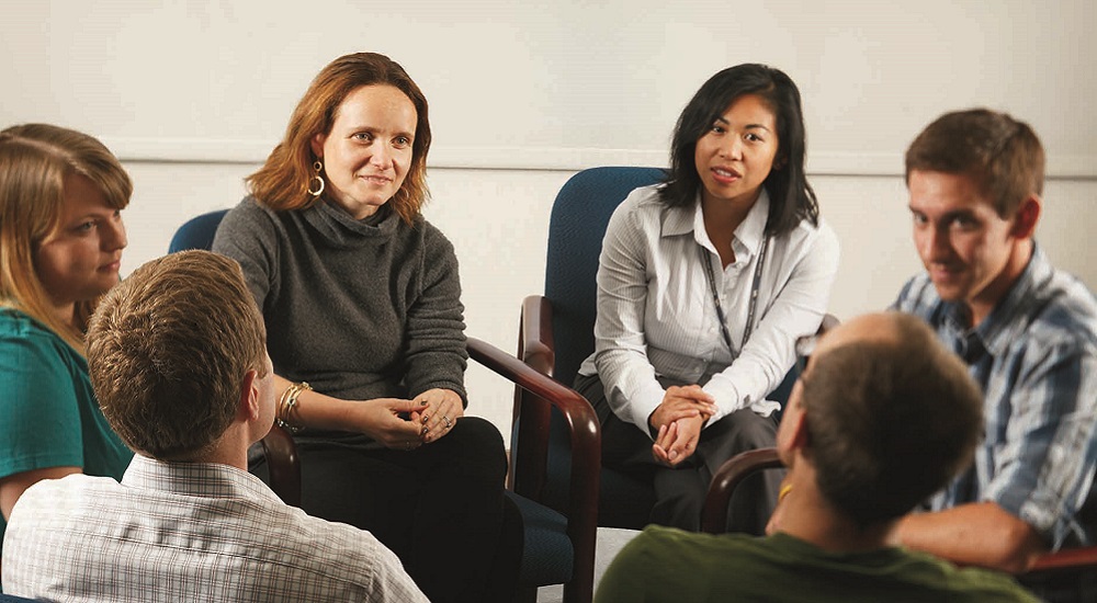 Dr. Sonya Norman, gray sweater, left, leads a meeting at the San Diego VA Medical Center regarding a talk therapy research program for Veterans who suffer from guilt and shame from deployment traumas.