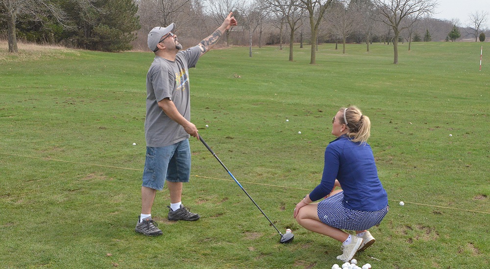 Ray Martinez gets advice on his golf swing from volunteer instructor Erika Pirkl, Player Development Coordinator with Wisconsin PGA.