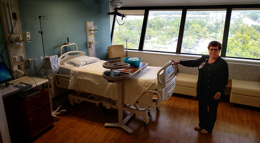 A female nurse presents an upgraded hospital room