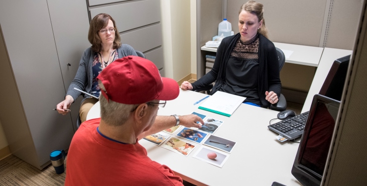 IMAGE: SLP Sarah Kiefer Luhring (left) observes VA Pittsburgh staff SLP Ronda Winans Mitrik and Army Veteran Frank Shandorf of Greensburg, Pennsylvania,during an aphasia therapy session with photos of common objects to spur language recall.