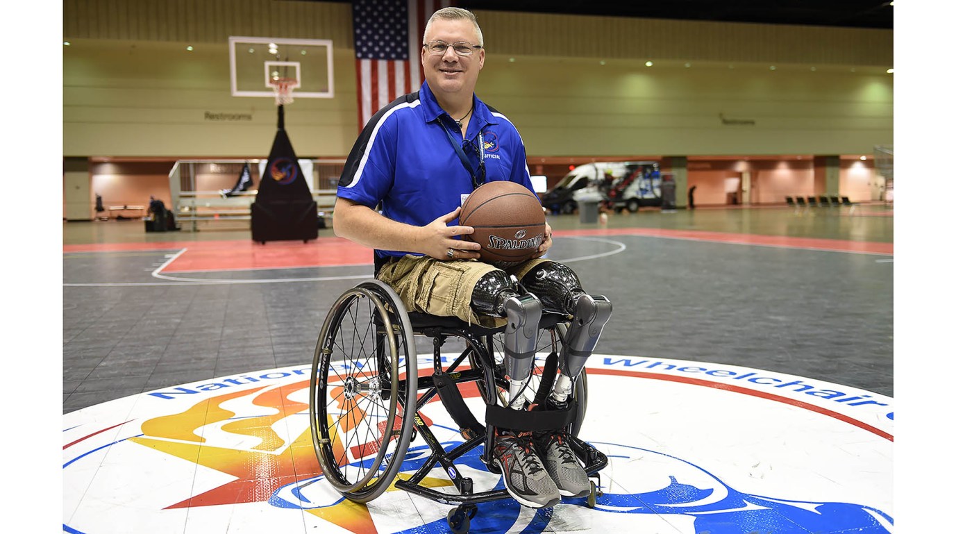 Man in wheelchair holding basketball