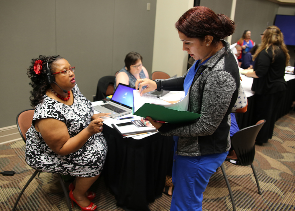 Tamara Monroe, Community Care manager for the southern region and other VA staff members assist vendors attending the vendor health care fair at the UTRGV Academic and Clinical Research Building in Harlingen, Texas, on August 9, 2018. (U.S. Department of Veterans Affairs photo by Luis H. Loza Gutierrez)