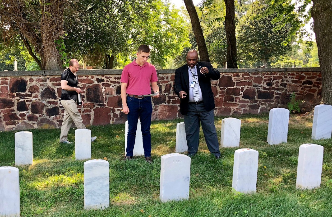 IMAGE: James Sanders, center, Quantico National Cemetery Director, speaks to students from Defense Information School (DINFOS), during a site visit to Alexandria National Cemetery (ANC) July 13, 2018. DINFOS provides its students an opportunity to work with local organizations and businesses within the Fort Meade, Maryland area, to produce the student’s capstone presentation.