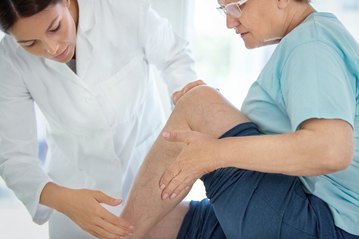 doctor examining patient's leg