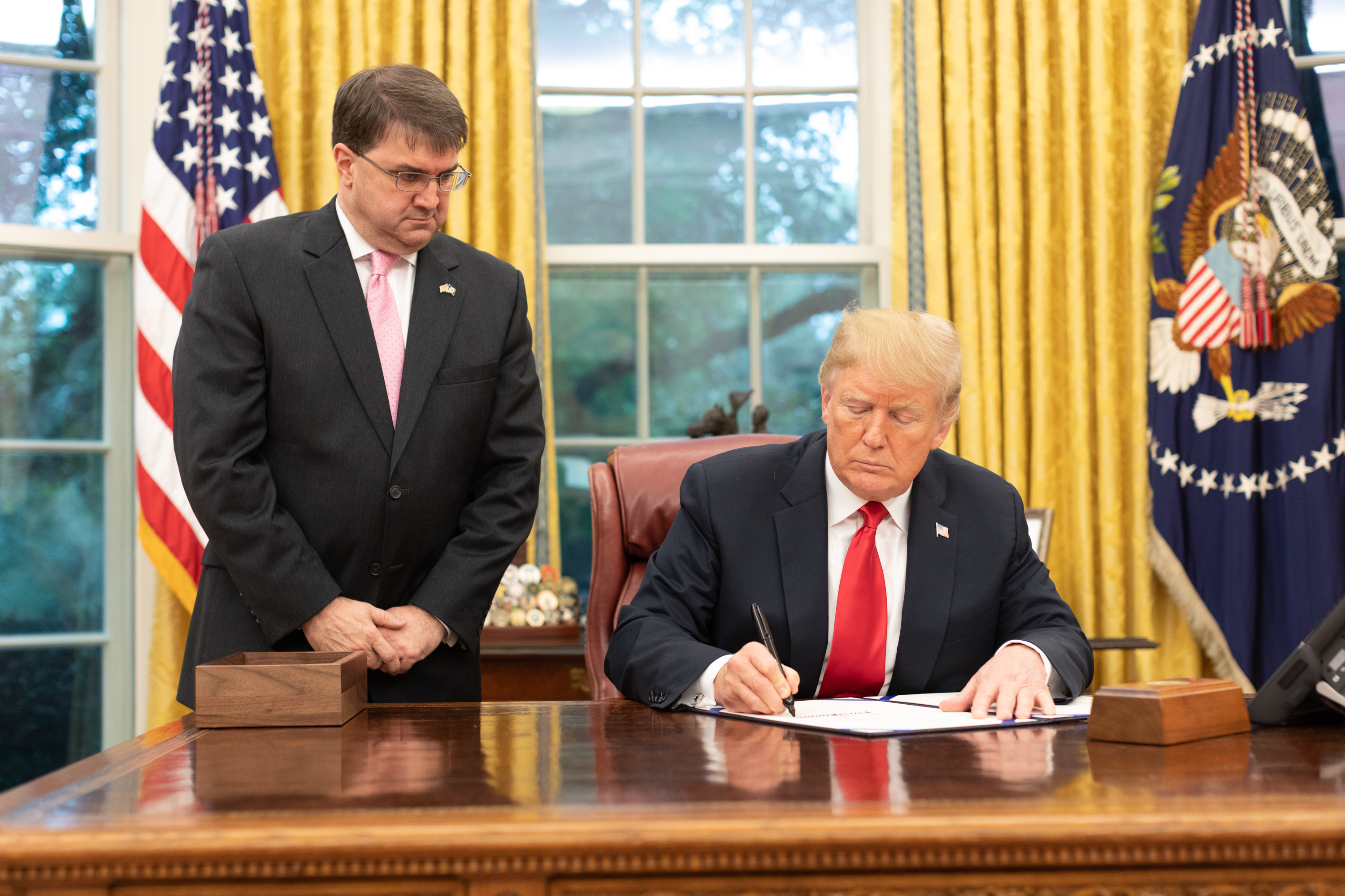 President Donald J. Trump, joined by U.S. Secretary of Veterans Affairs Robert Wilkie, signs H.R. 2147, The Veterans Treatment Court Improvement Act of 2018 Monday, Sept. 17, 2018, in the Oval Office of the White House. (Official White House Photo by Joyce N. Boghosian)