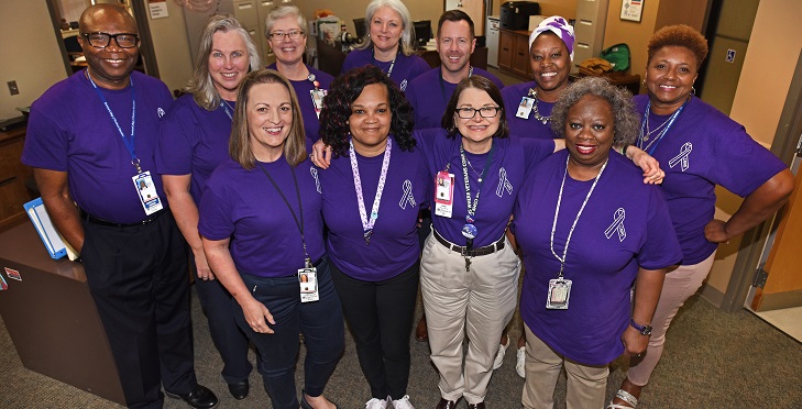 IMAGE: Pictured above: Central Arkansas Veterans Health care leadership and create a ‘sea of purple’ with special Intimate Partner Violence (IPV) awareness T-shirts.  CAVHS employees are encouraged to wear the shirts every Friday in October to bring awareness to, and prevention of, intimate partner violence.  (VA photo by Jeff Bowen.)