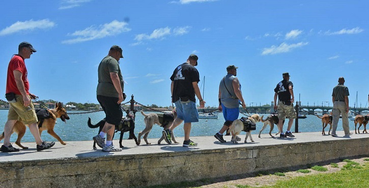 IMAGE: K9s For Warriors veterans walking with their service dogs